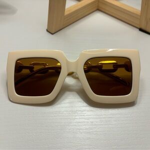 Women’s oversized white and gold sunglasses